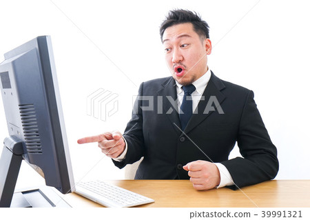 Businessman scolding in front of a personal computer Businessman scolding in front of a personal computer 39991321