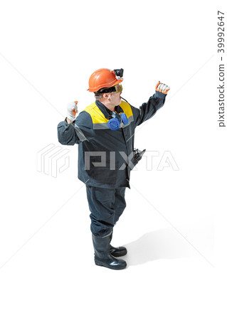 The studio shot of senior bearded male miner standing at the camera on a white background. The studio shot of senior bearded male miner standing at the camera on a white background. 39992647