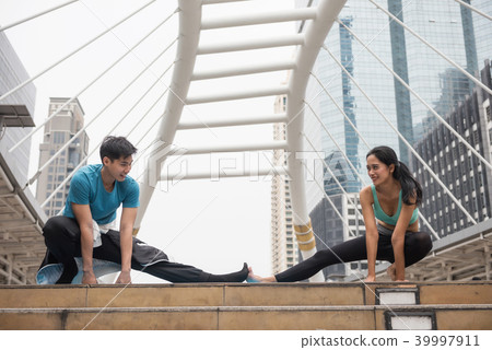 couple stretch legs and perform yoga couple stretch legs and perform yoga 39997911