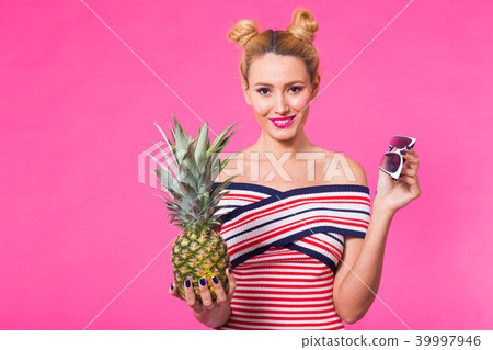 Fashion portrait funny woman with pineapple over pink background Fashion portrait funny woman with pineapple over pink background 39997946