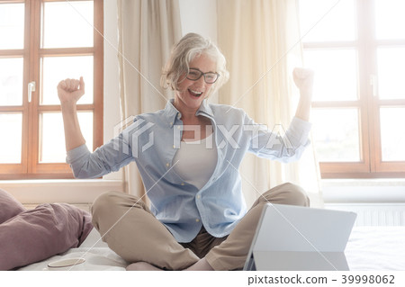 Senior business woman being excited about a success  39998062
