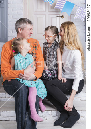 Family portrait on porch of the house 39998467