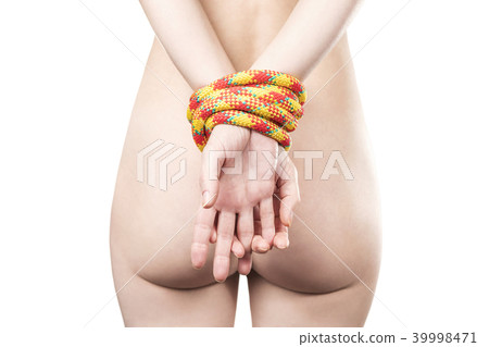 Hands bound by rope behind 39998471