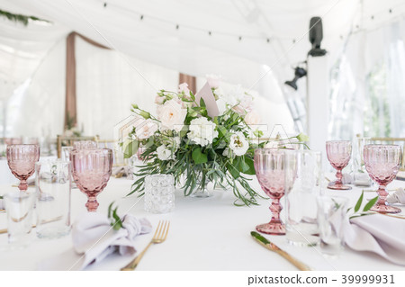 Beautiful table setting with crockery and flowers Beautiful table setting with crockery and flowers 39999931
