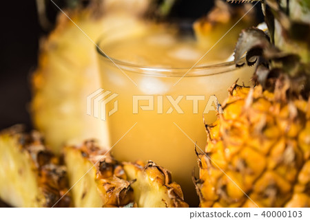 Pineapple juice and slice placed on a wooden table 40000103