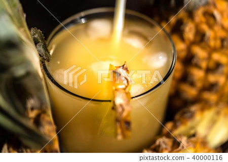Pineapple juice and slice placed on a wooden table Pineapple juice and slice placed on a wooden table 40000116