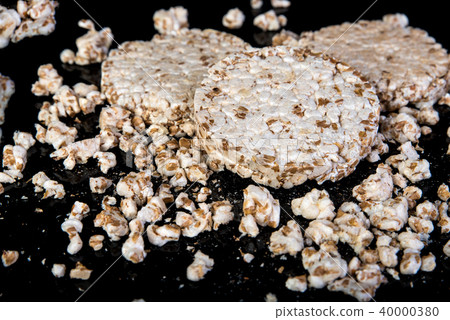 Wheat grain crispbread on black, diet eating Wheat grain crispbread on black, diet eating 40000380