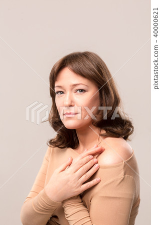 young beautiful woman in beige blouse young beautiful woman in beige blouse 40000621