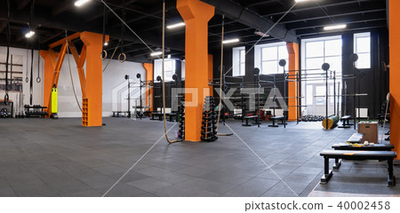 Spacious modern interior of the gym for fitness training 40002458