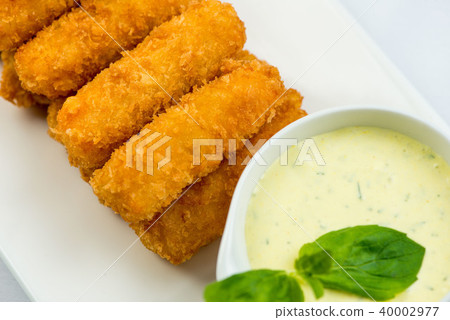 Meat fried in batter with dill in squared plate over white background 40002977