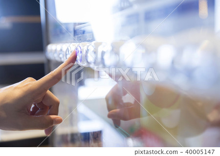 Female hand pressing button on vending machine Female hand pressing button on vending machine 40005147