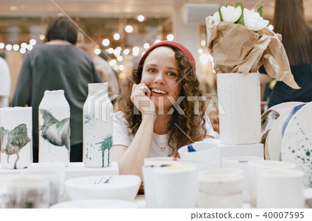 Charming woman among clay artisan utensil Charming woman among clay artisan utensil 40007595