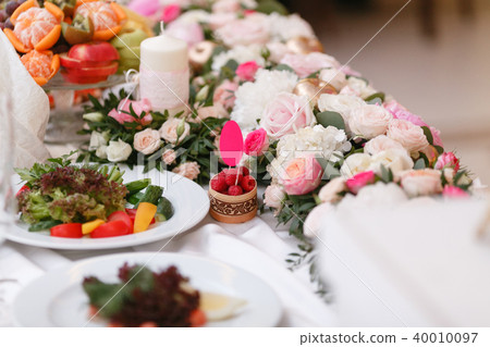 Luxury wedding reception in restaurant. stylish decor and adorning. Restaurant table with food 40010097