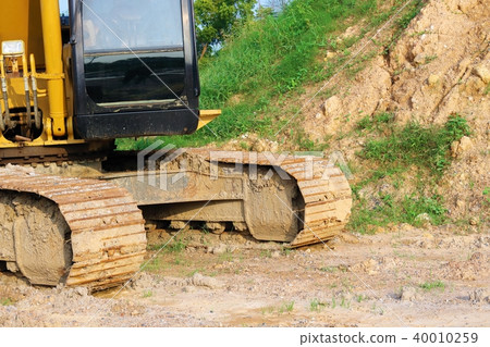 Heavy yellow excavator are moving on site. 40010259