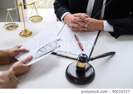 Bribery and corruption concept, bribe in the form of dollar bill Bribery and corruption concept, bribe in the form of dollar bill 40010327