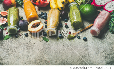 Colorful smoothies in bottles with fresh fruit, copy space 40012894