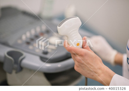 sonographer using ultrasound machine at work 40015326
