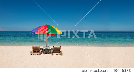 umbrella with beach chairs on the white sand umbrella with beach chairs on the white sand 40016378