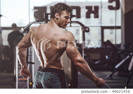 handsome strong bodybuilder men pumping up muscles 40021458