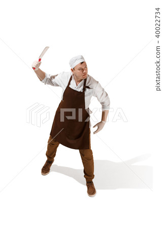 Angry aggressive butcher posing with a cleaver isolated on white background 40022734