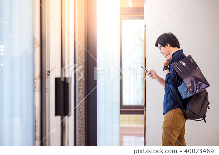 Asian man holding shopping bag in department store Asian man holding shopping bag in department store 40023469