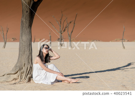 Asian girl in white dress in Deadvlei, Namibia 40023541