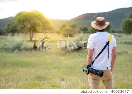Young male traveler standing in safari, Africa 40023657
