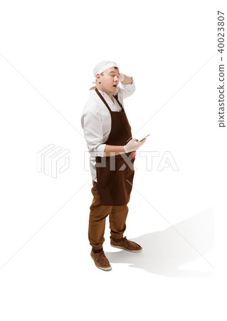 Smiling butcher posing with a cleaver isolated on white background 40023807