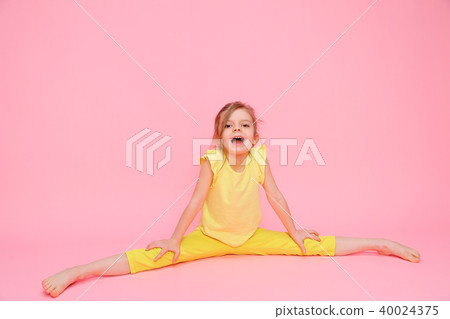 Happy stretching girl on pink 40024375