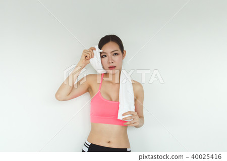 Sports concept. Beautiful girl is exercising in the home with wa Sports concept. Beautiful girl is exercising in the home with wa 40025416
