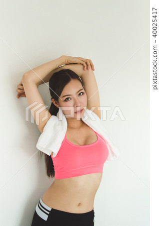 Sports concept. Beautiful girl is exercising in the home with wa Sports concept. Beautiful girl is exercising in the home with wa 40025417