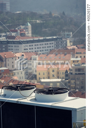 Air conditioning ventilators on roof with houses 40026577