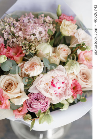 bouquet of beautiful flowers with peony on gray table. Floristry concept. Spring colors. the work of bouquet of beautiful flowers with peony on gray table. Floristry concept. Spring colors. the work of 40026742