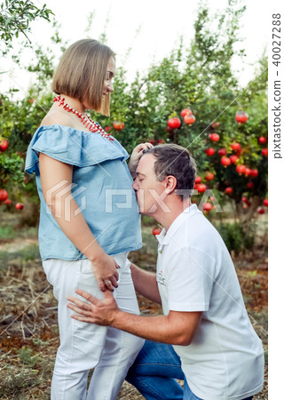 Portrait of young woman picking rpomegrate fruits Portrait of young woman picking rpomegrate fruits 40027288