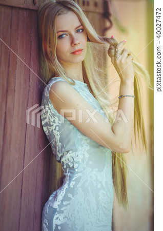 Attractive modest young blond woman playing  Attractive modest young blond woman playing  40027472