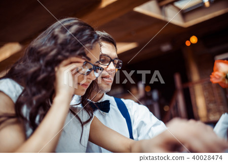 Romantic couple in love bonding in cafe Romantic couple in love bonding in cafe 40028474