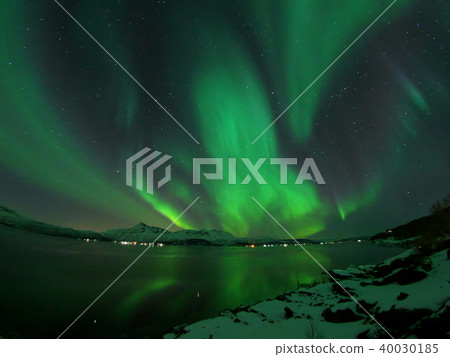 Violently dancing aurora reflected in fjord Violently dancing aurora reflected in fjord 40030185