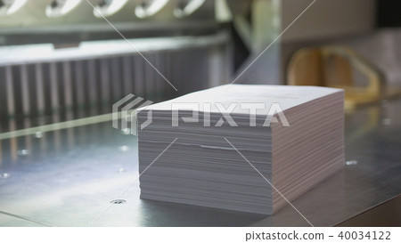 Typography - stack of paper near cutting machine 40034122