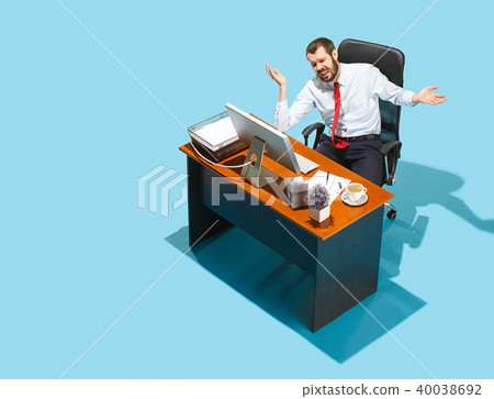 Shot from above of a stylish business man working on a laptop. Shot from above of a stylish business man working on a laptop. 40038692