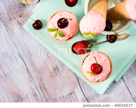 Home made strawberry ice cream served in cones Home made strawberry ice cream served in cones 40038837