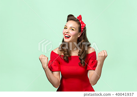 Beautiful young woman with pinup make-up and hairstyle. Studio shot on white background 40041937