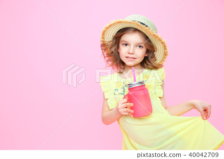 Stylish little girl with drink on pink Stylish little girl with drink on pink 40042709