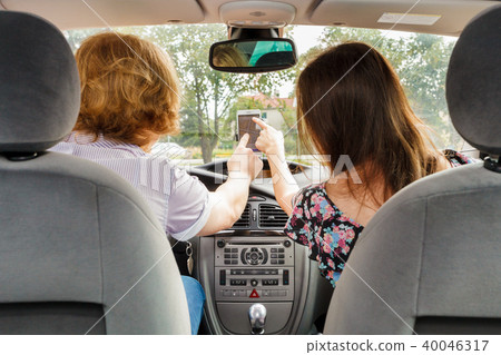 Man and woman in car setting gps Man and woman in car setting gps 40046317