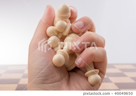 Chess board with chess pieces in hand 40049650