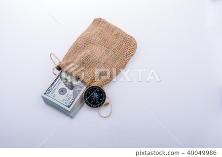 Compass and bundle of US dollarin a sack Compass and bundle of US dollarin a sack 40049986