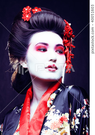 young pretty geisha in kimono with sakura and decoration on blac 40051603
