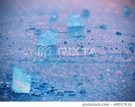 Selective focus, ice floes reflected sunset colors 40057616
