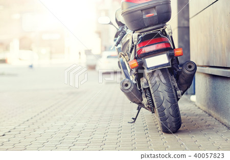 close up of motorcycle parked on city street 40057823