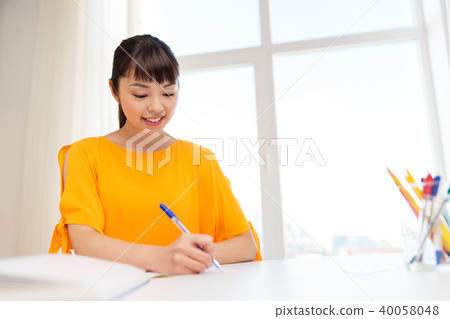 happy student girl with book and notebook at home 40058048