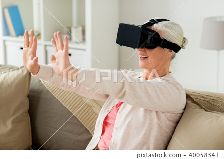 old woman in virtual reality headset or 3d glasses old woman in virtual reality headset or 3d glasses 40058341